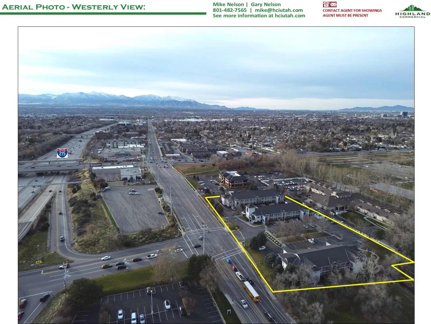 Aerial view of property and surrounding area with property parcel outlined and a mountain backdrop