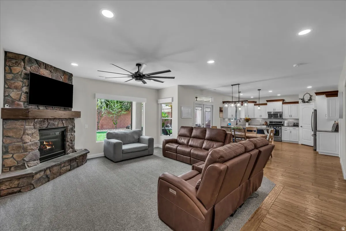 Living area featuring ceiling fan, a fireplace, and recessed lighting