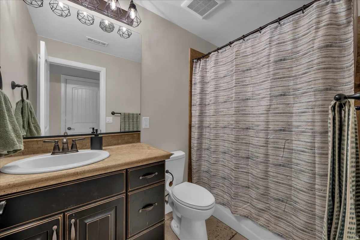 Full bathroom with vanity and shower / bathtub combination with curtain