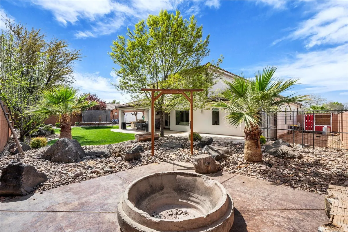 Fenced backyard featuring a patio area and an outdoor fire pit