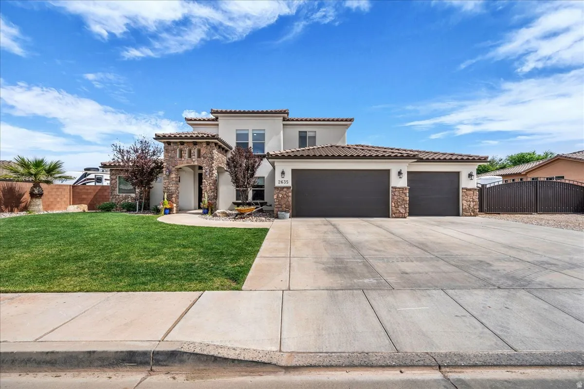 Mediterranean / spanish home featuring stone siding, a garage, concrete driveway, stucco siding, and a tiled roof