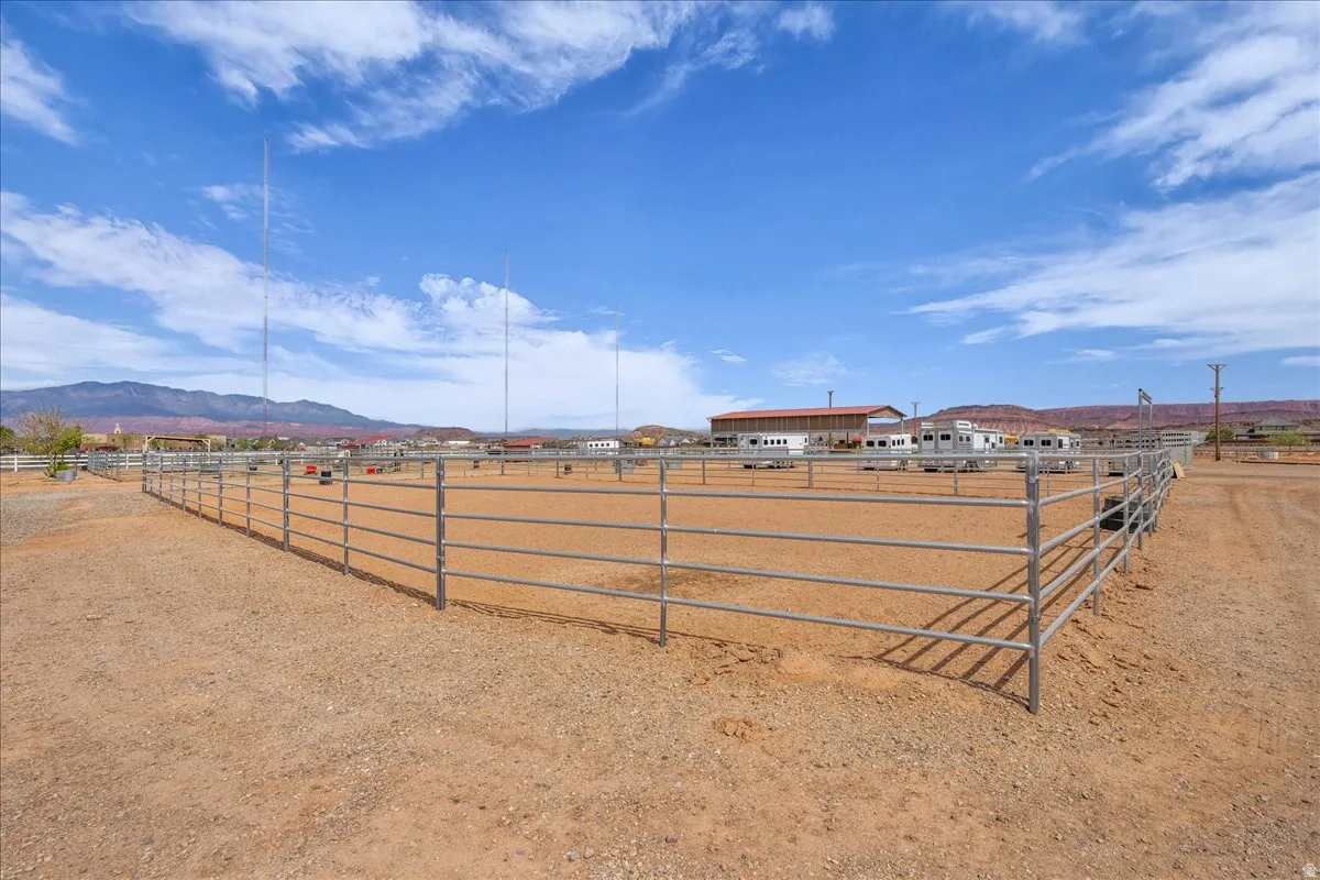 View of yard with an enclosed horse arena, a mountain view, and a view of countryside