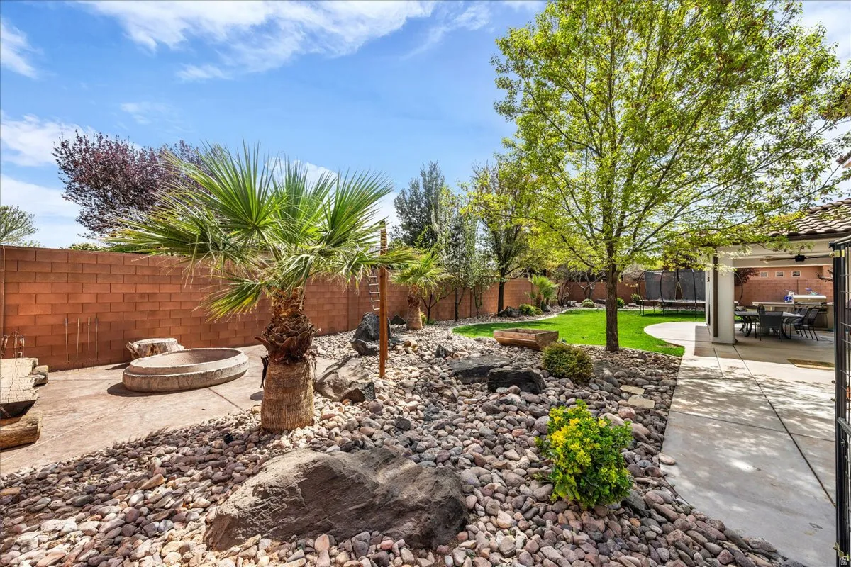 Fenced backyard featuring a patio and a fire pit