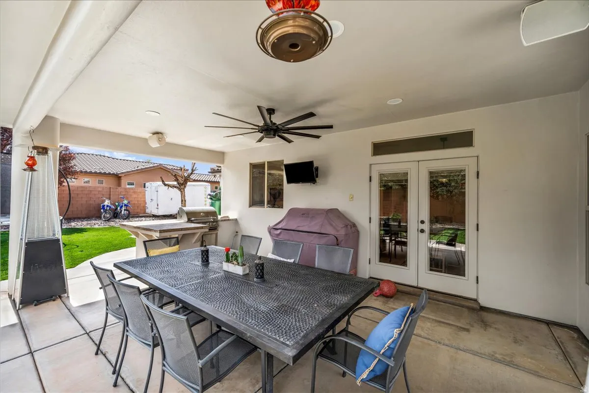 View of patio featuring outdoor dining space, ceiling fan, french doors, and area for grilling