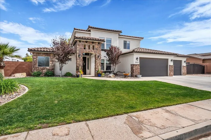 Mediterranean / spanish-style home featuring stone siding, an attached garage, concrete driveway, and stucco siding