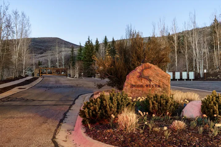 View of asphalt road featuring curbs and a mountain view