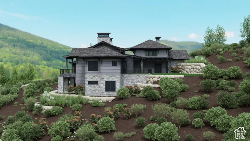 Modern mountain architecture featuring a multi-level design, stone and siding exterior, multiple balconies, and a dark shingle roof