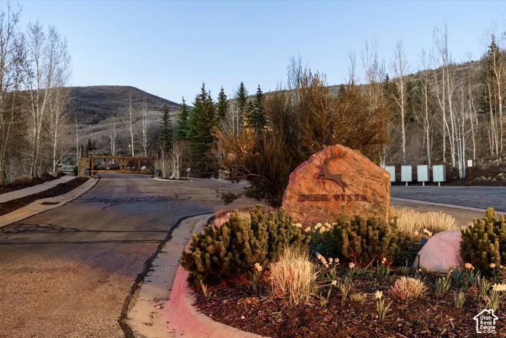 View of asphalt road featuring curbs and a mountain view