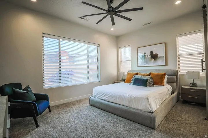 Bedroom with a ceiling fan, carpet floors, and recessed lighting