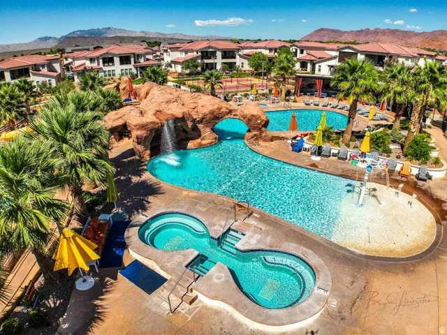 Community pool featuring a patio, a community hot tub, a mountain view, and a residential view