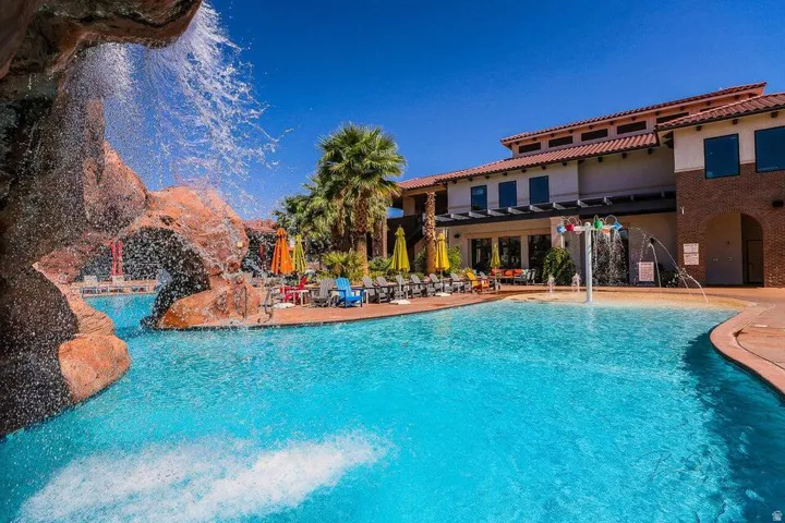 Community pool featuring a patio area and a pergola