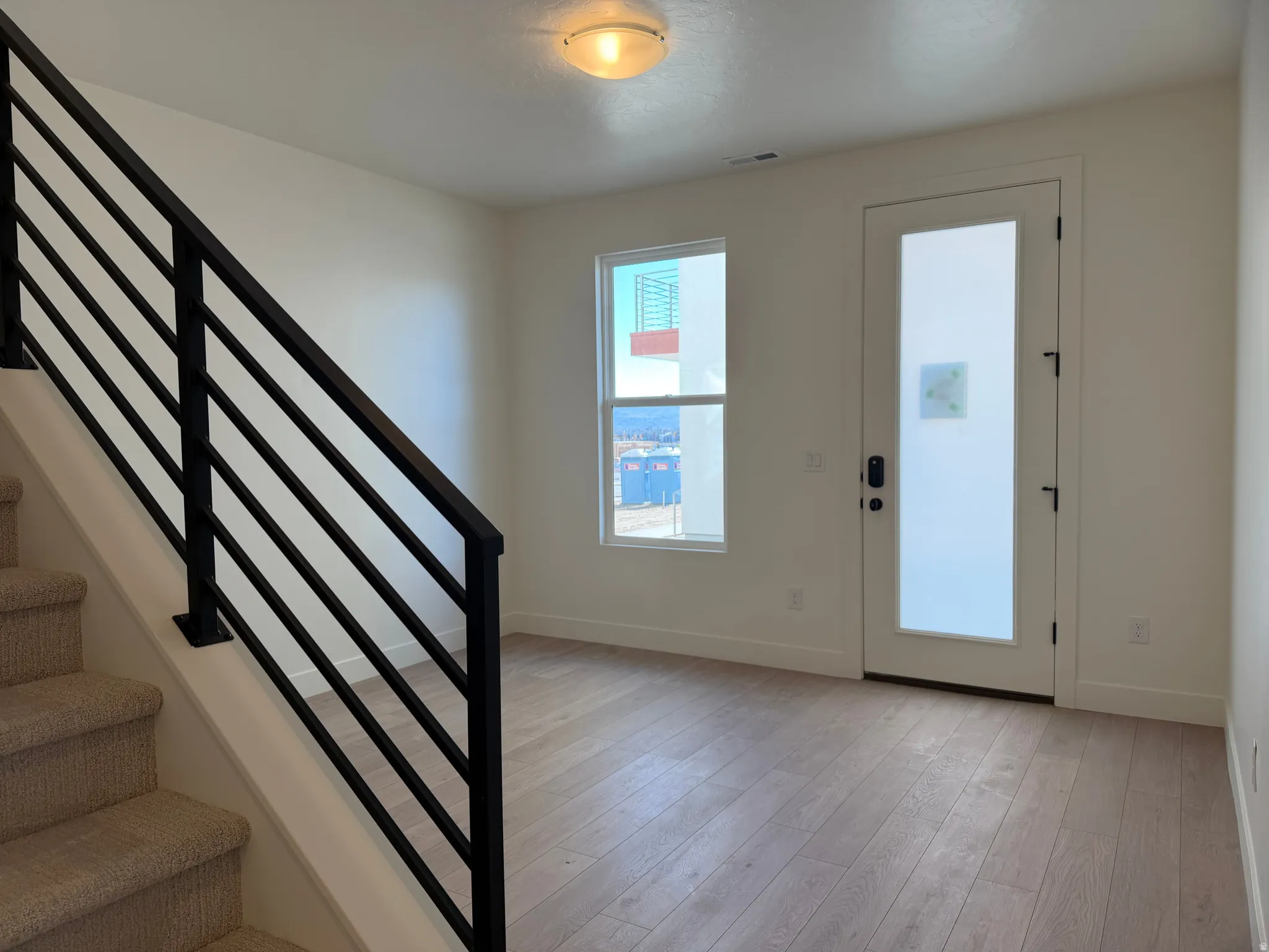 Entrance foyer with stairs and light wood finished floors