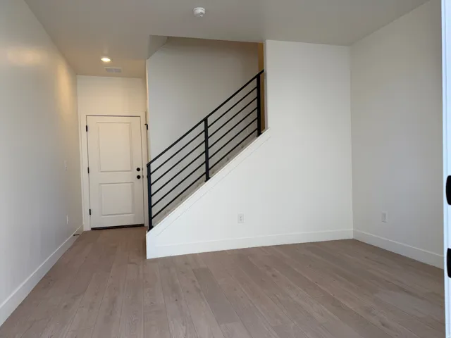 Staircase featuring hardwood / wood-style flooring and recessed lighting
