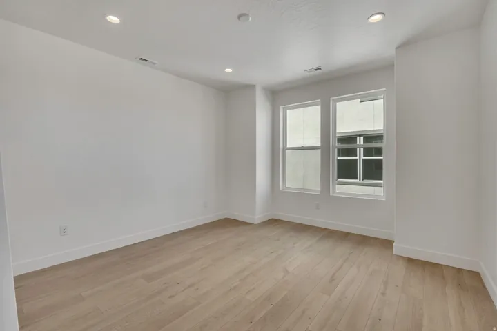 Empty room with recessed lighting and light wood-style floors