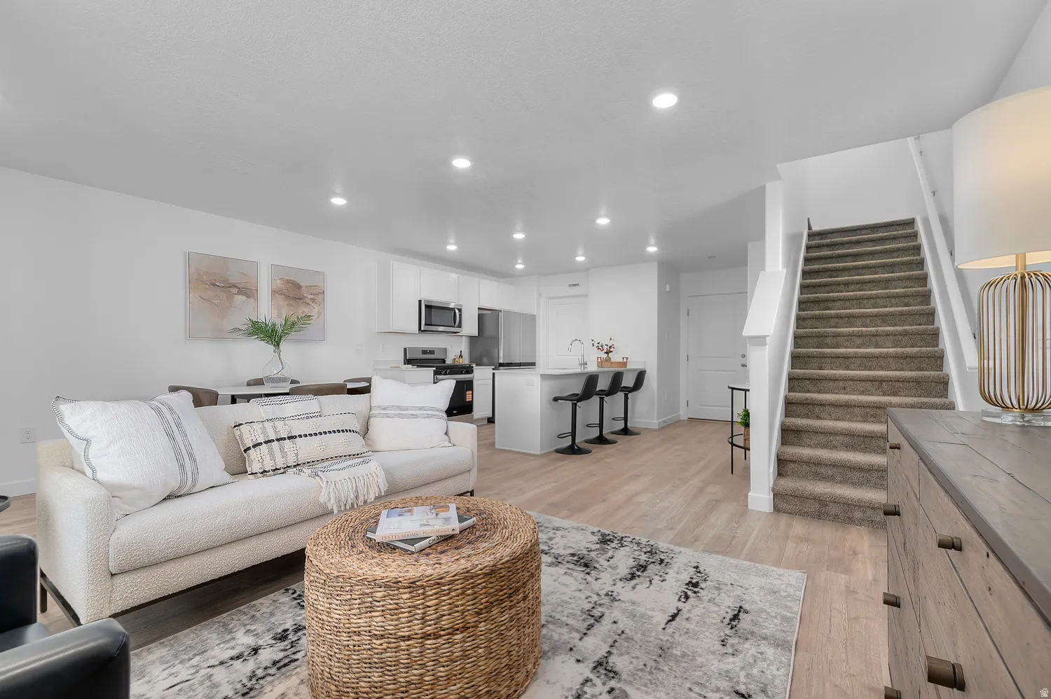 Living area featuring light wood-style floors and recessed lighting