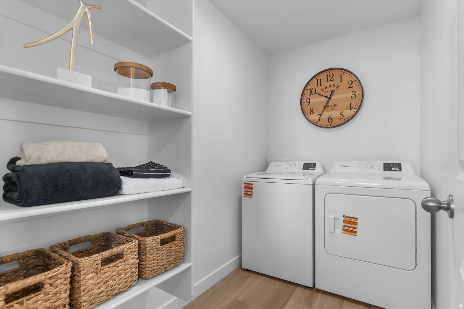 Laundry room featuring light wood finished floors and washing machine and clothes dryer