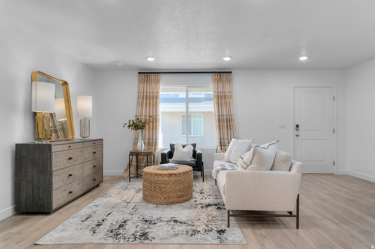 Living room featuring light wood-style floors, recessed lighting, and a textured ceiling