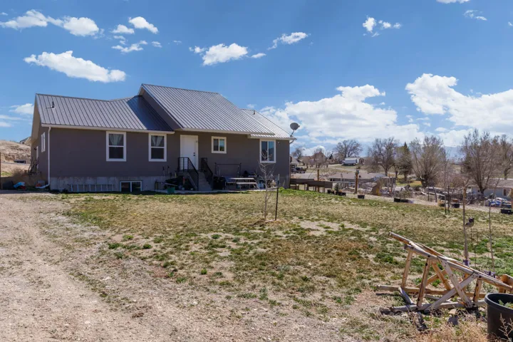 Back of property featuring a metal roof