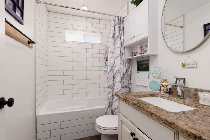 Full bathroom featuring vanity and shower / bath combo with shower curtain