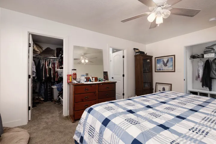 Primary Bedroom a spacious closet and ceiling fan