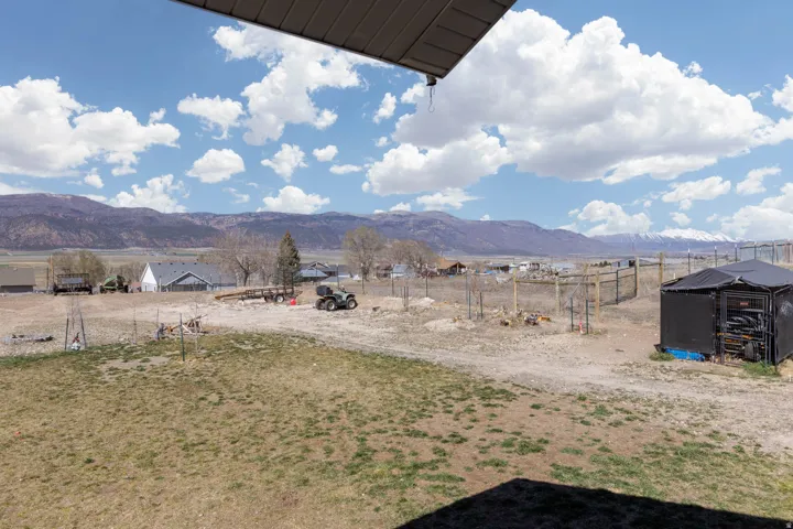 View of mountain backdrop featuring rural landscape