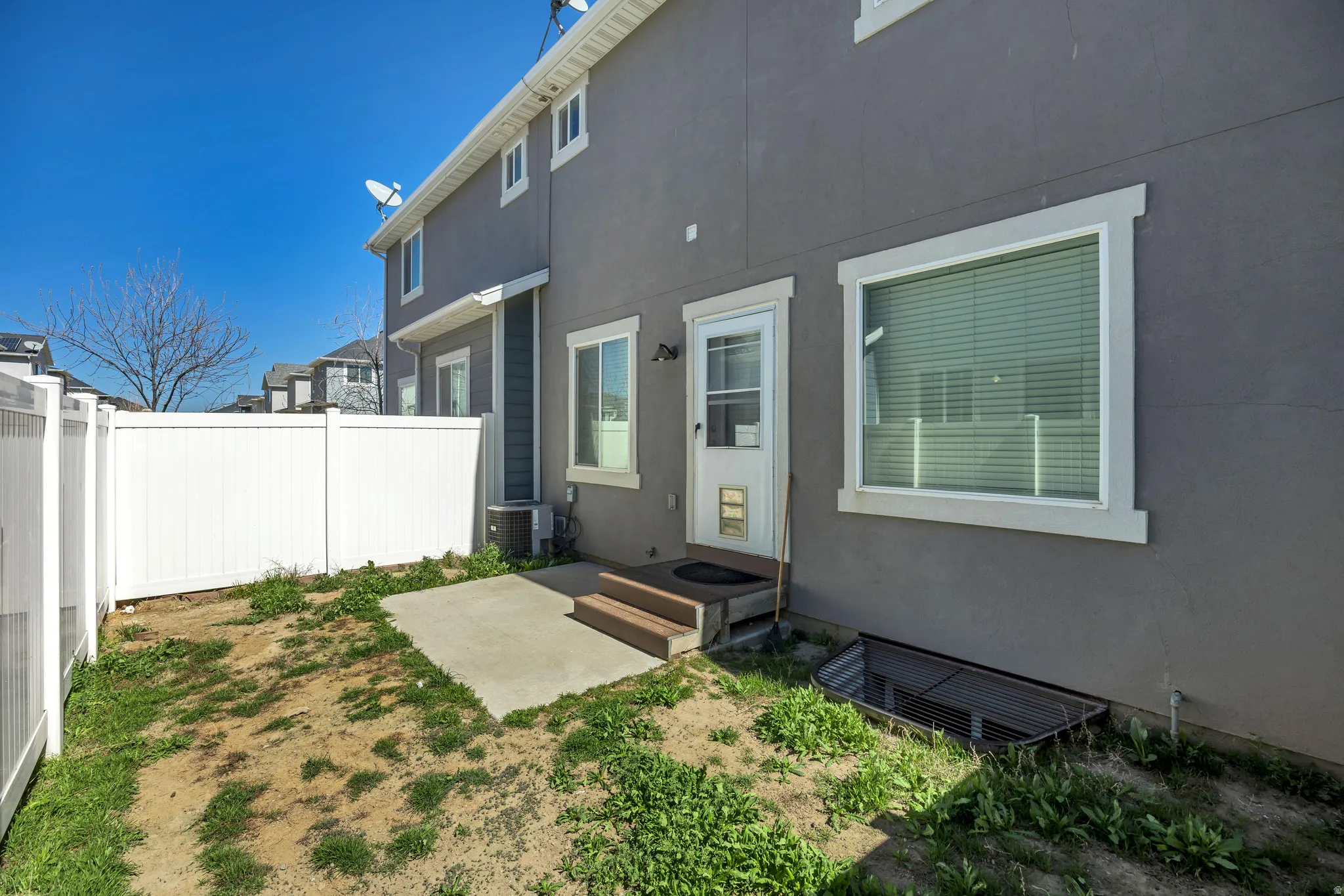 Back of property with stucco siding and a patio