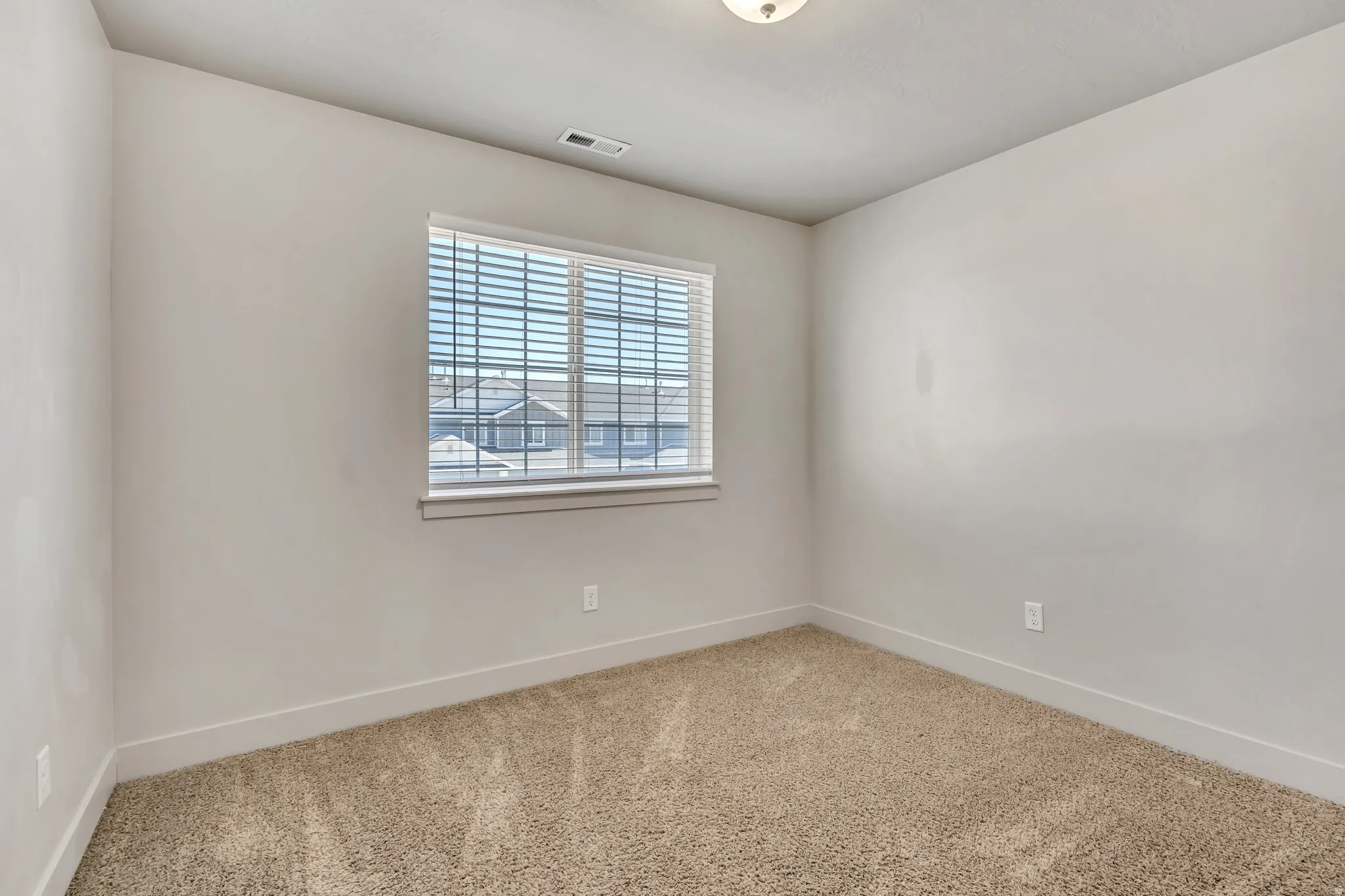 Spare room with carpet flooring and baseboards