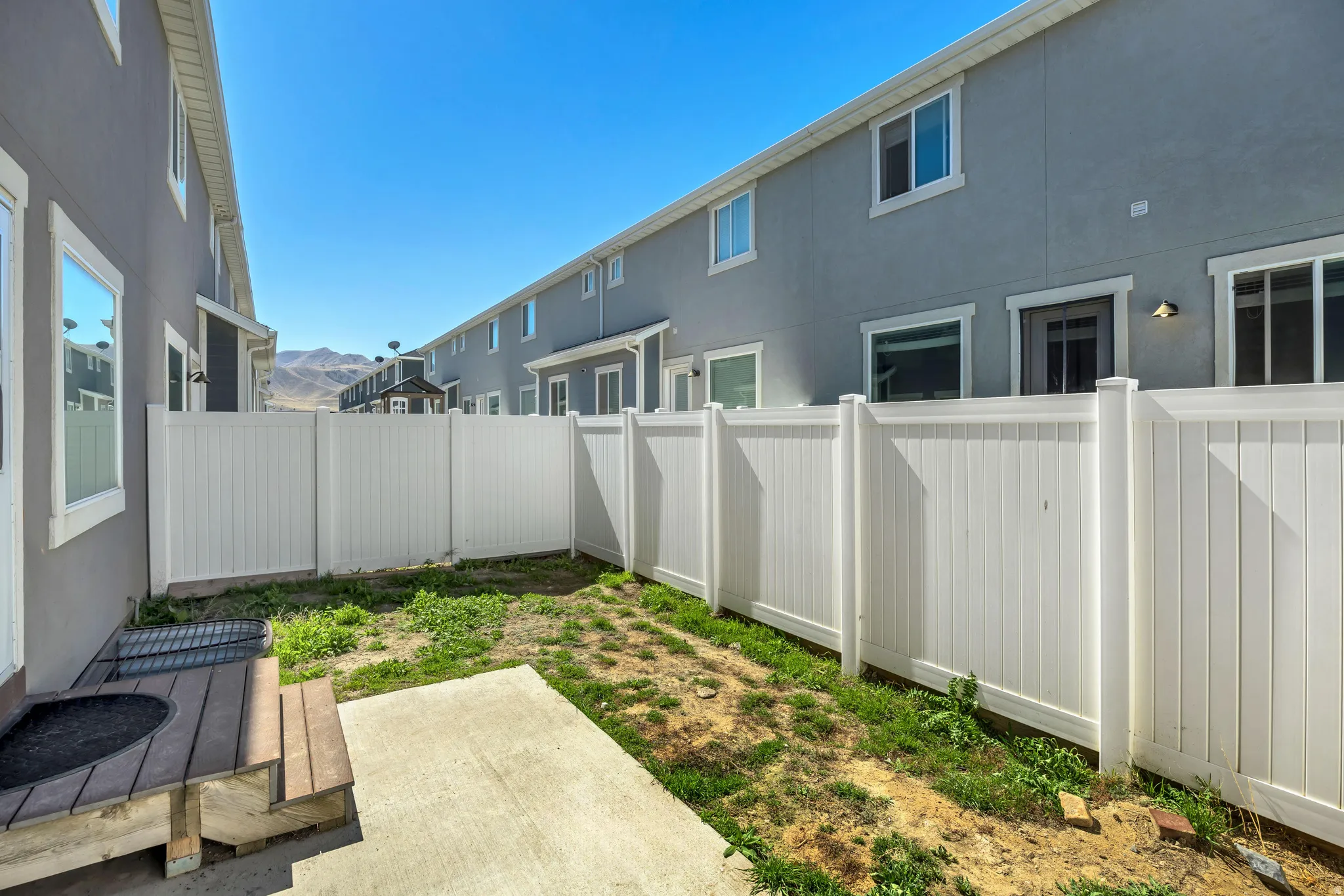 Fenced backyard featuring a patio area and a mountain view