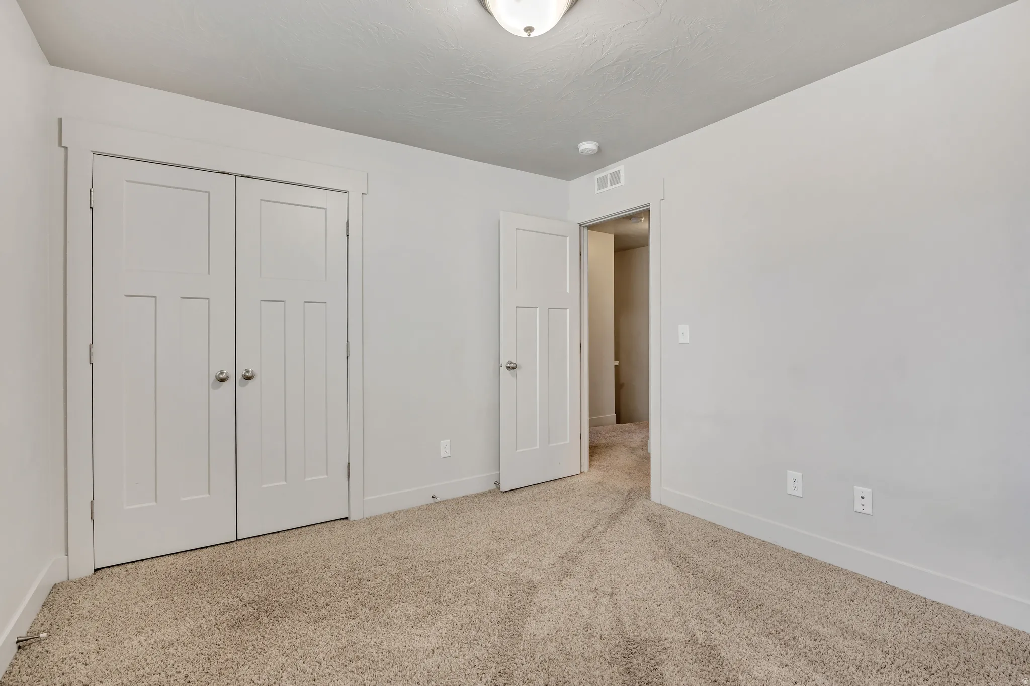 Unfurnished bedroom with a closet and carpet floors