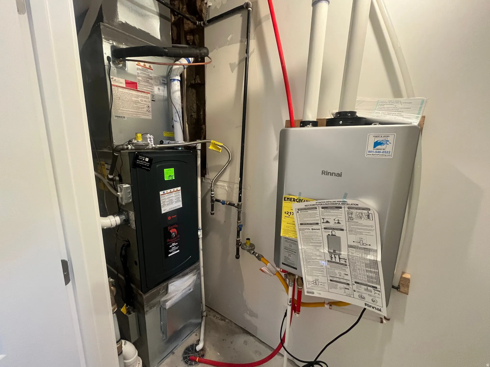 Utility room with tankless water heater and heating unit