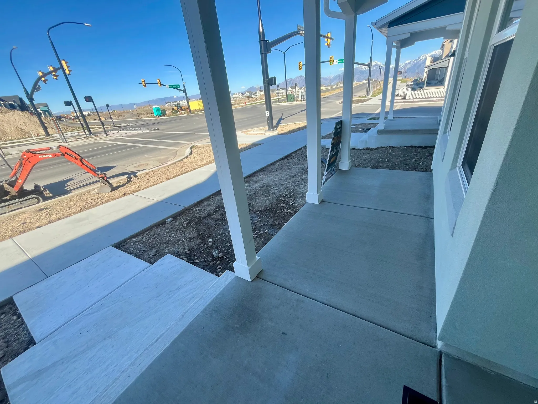 Covered porch featuring a mountain view