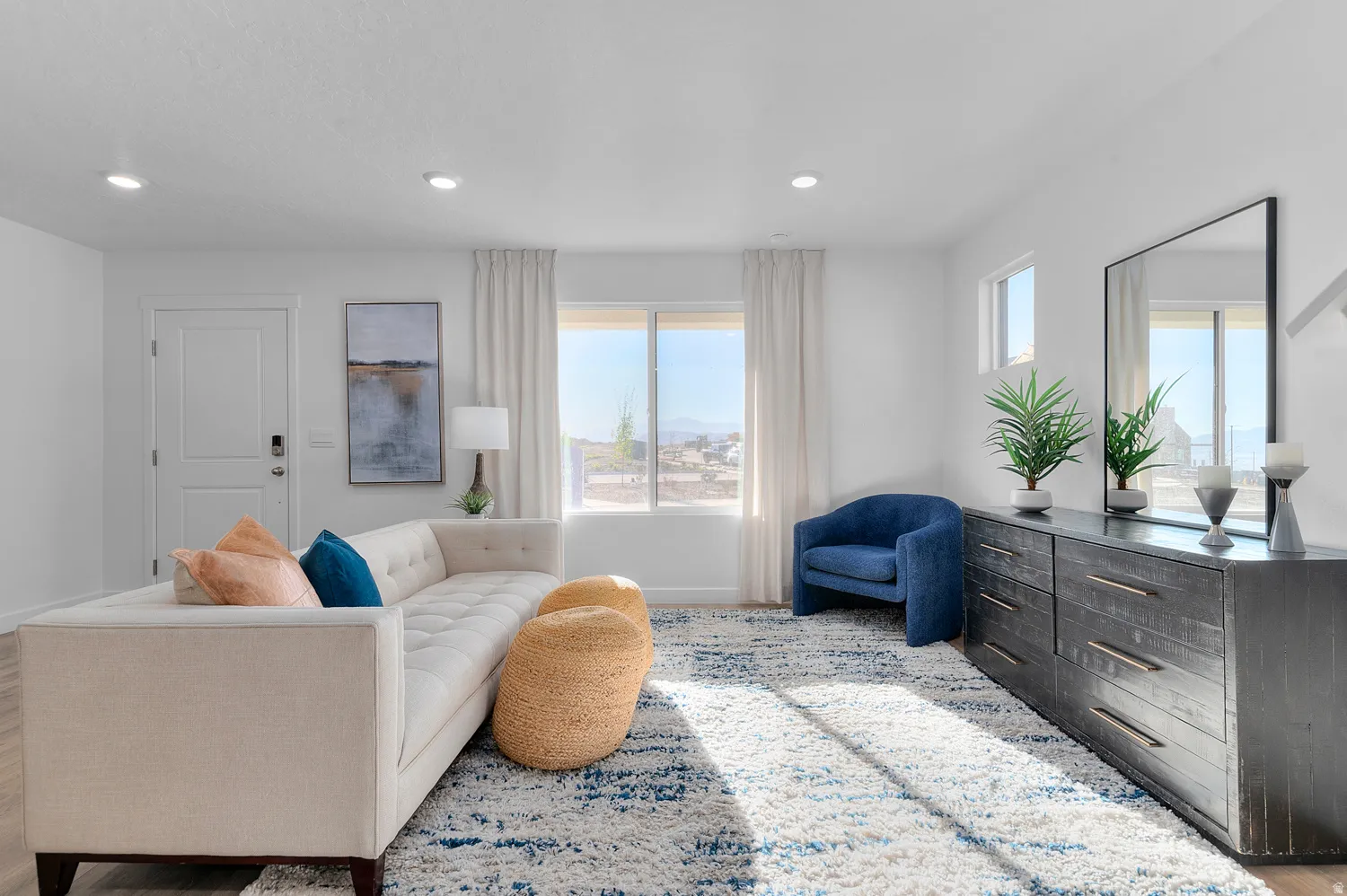 Living area featuring light wood-style flooring and recessed lighting