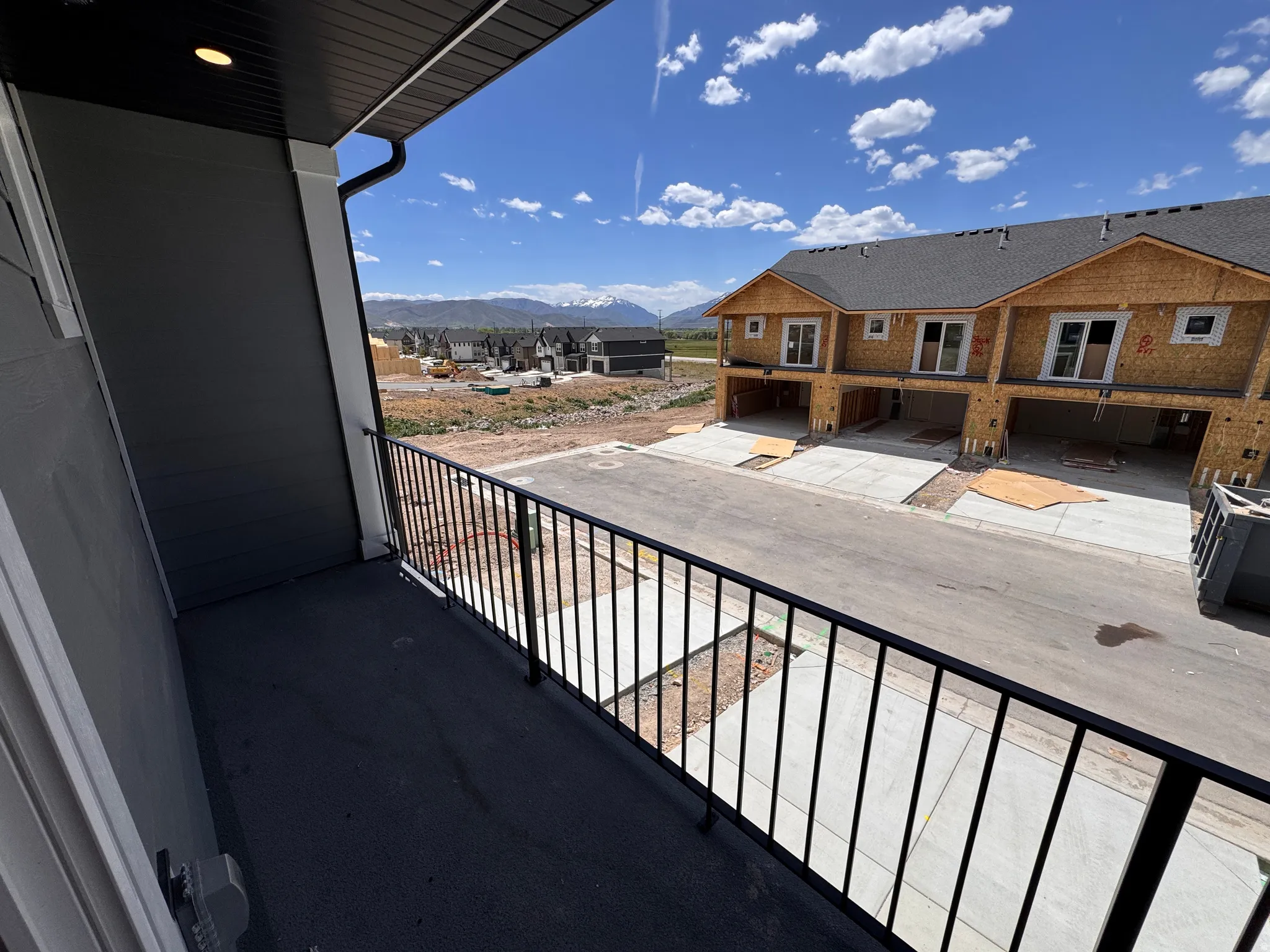 Private balcony with black railing and recessed lighting