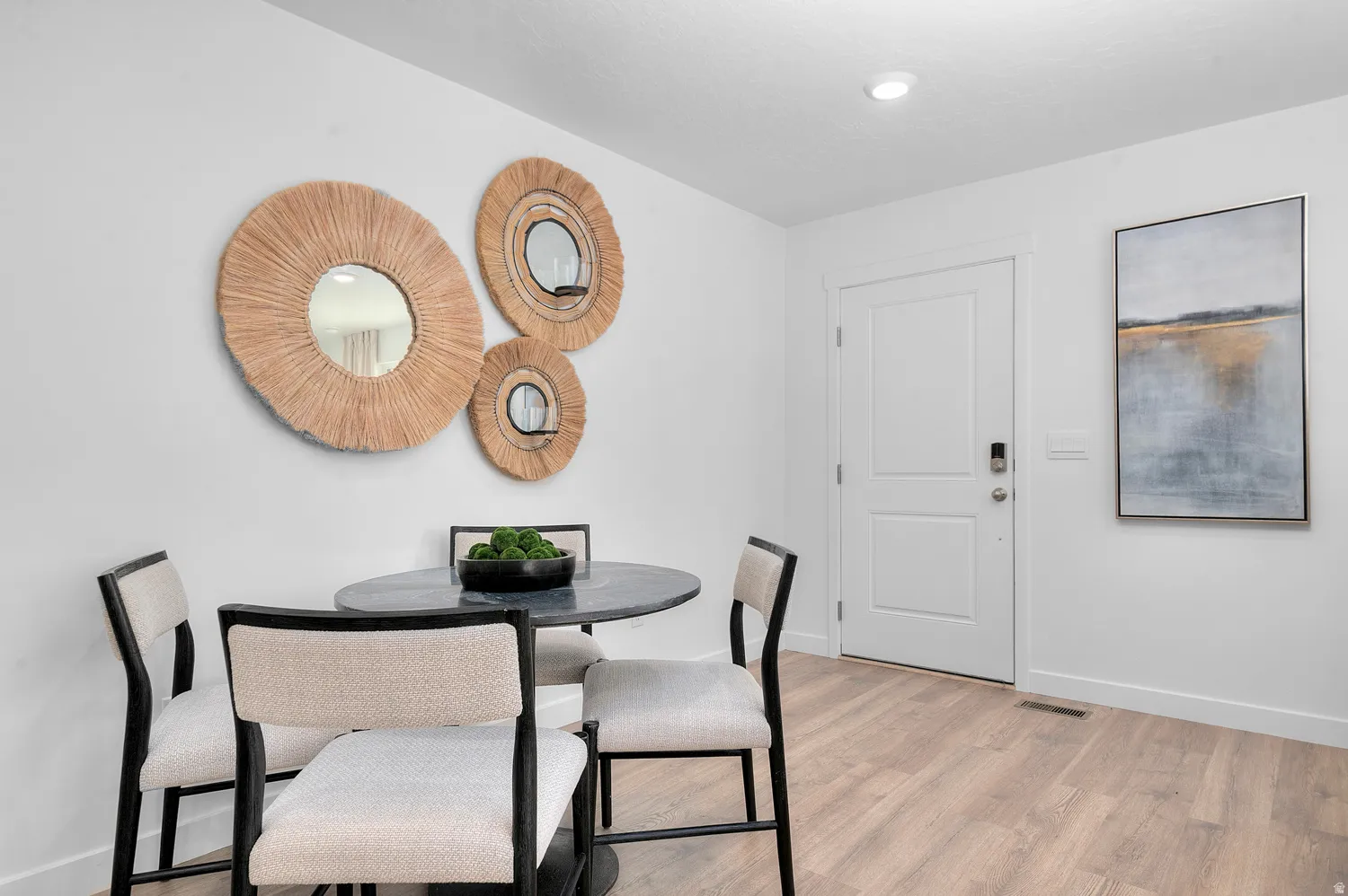 Dining room with light wood-type flooring and recessed lighting