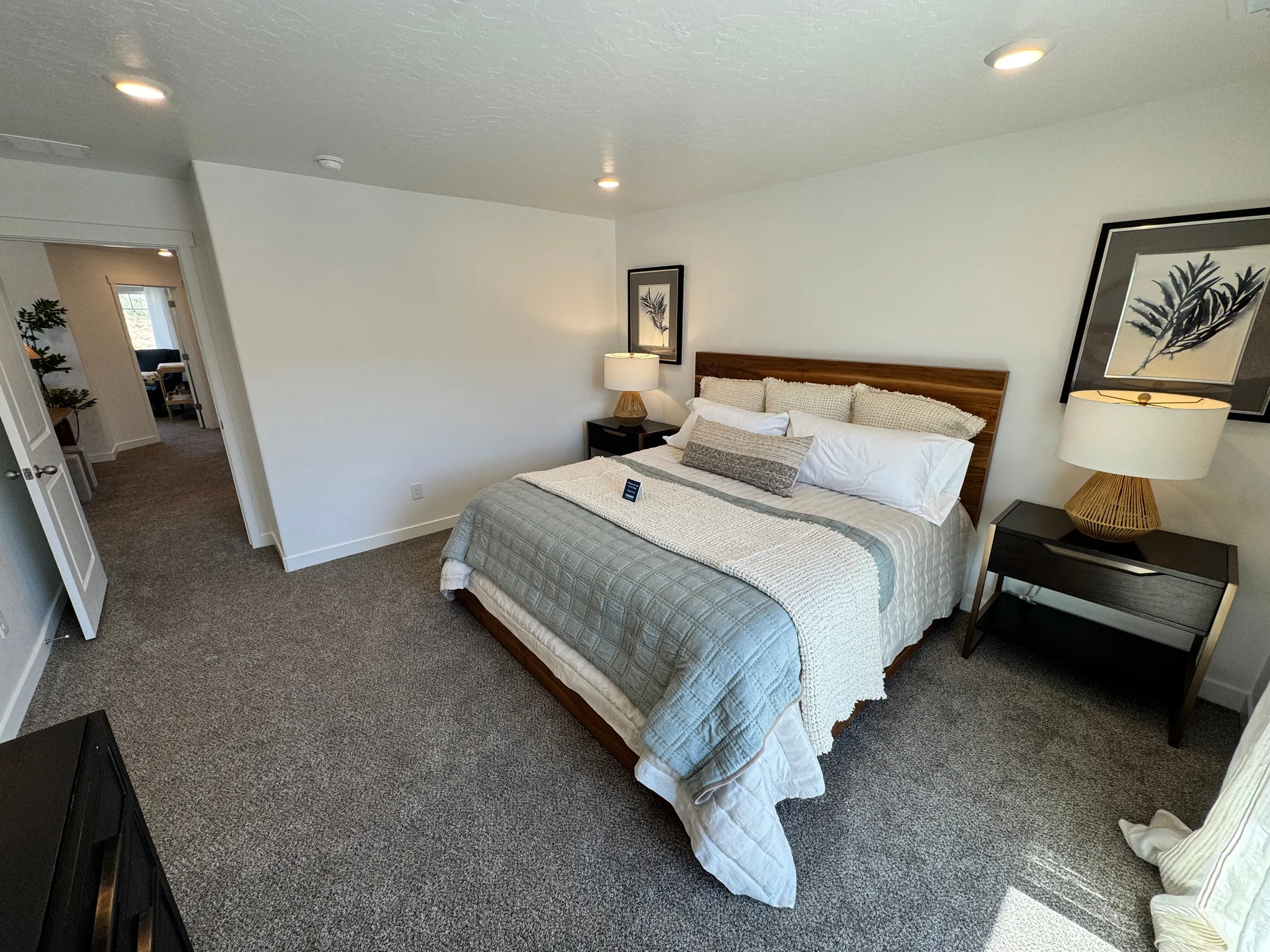 Carpeted room with recessed lighting and a wood-finish headboard