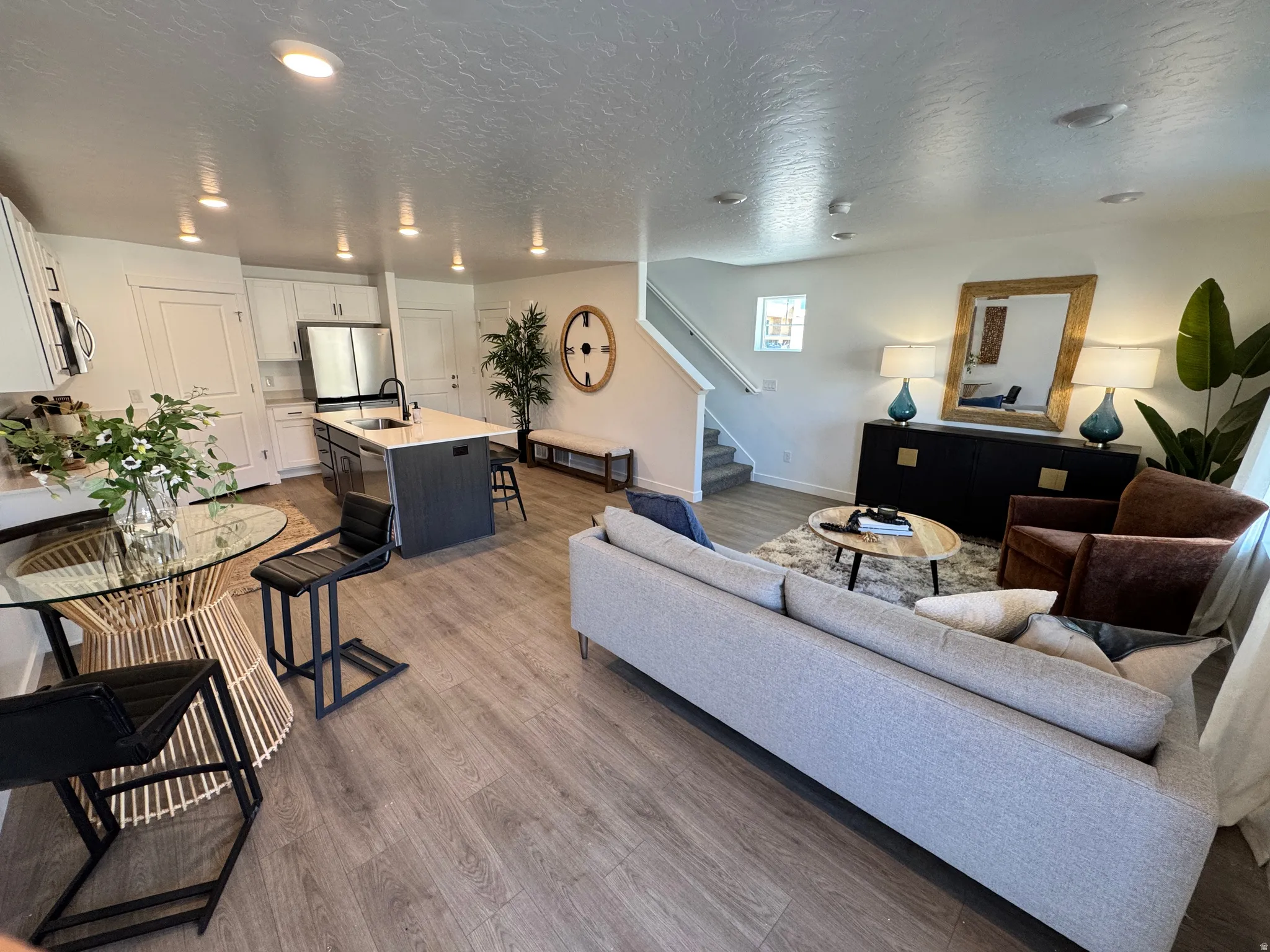 Open-concept living space featuring wood-finish flooring