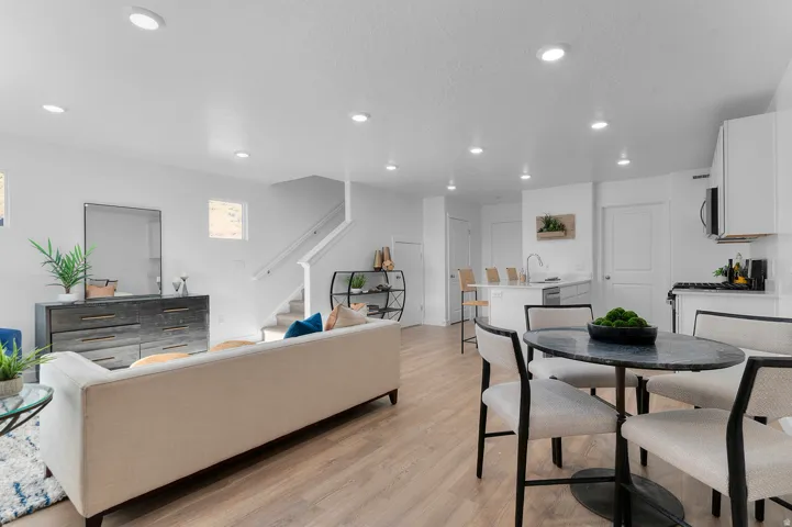 Dining area with light wood-type flooring and recessed lighting