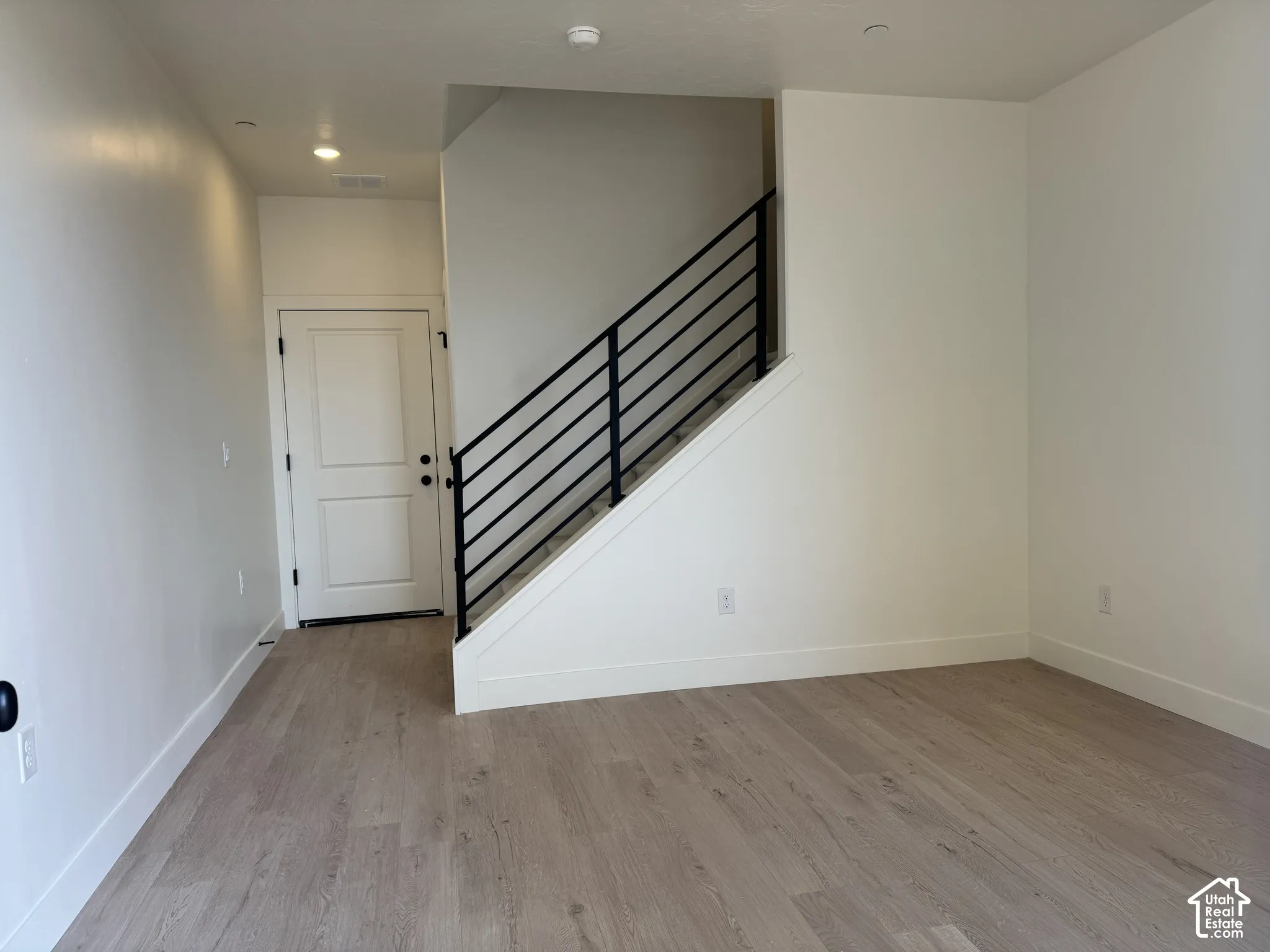 Entryway with light wood-style flooring and recessed lighting