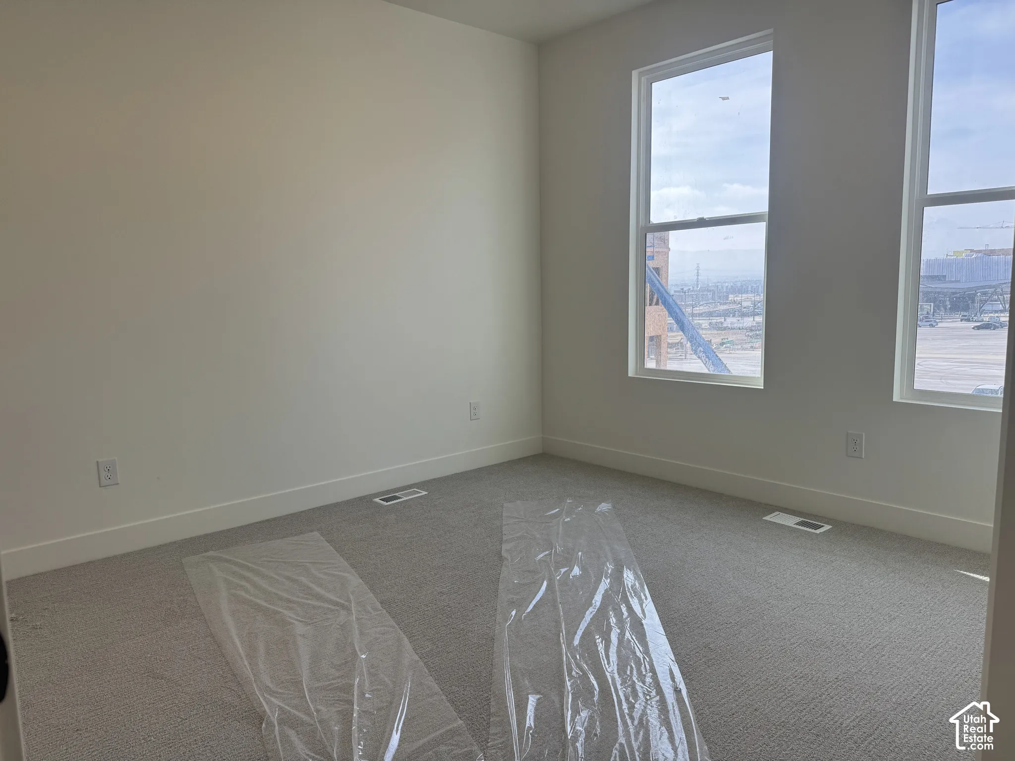 Unfurnished room with light carpet