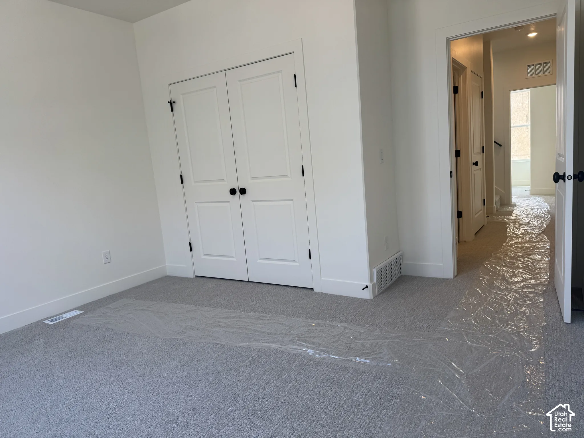 Unfurnished bedroom with carpet floors and a closet