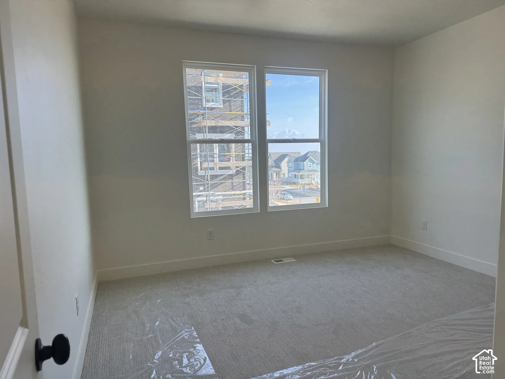 Primary bedroom featuring light colored carpet and a water view