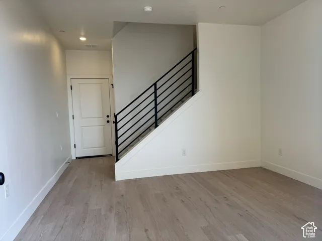Entryway with light wood-style flooring and recessed lighting