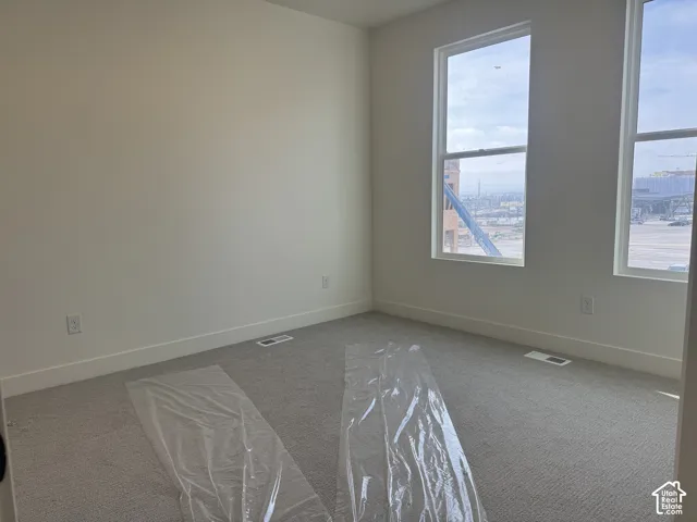 Unfurnished room with light carpet
