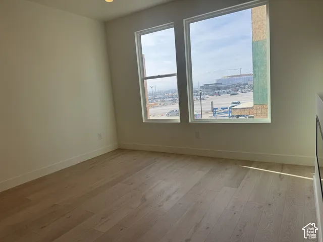 Spare room with light wood-type flooring and recessed lighting