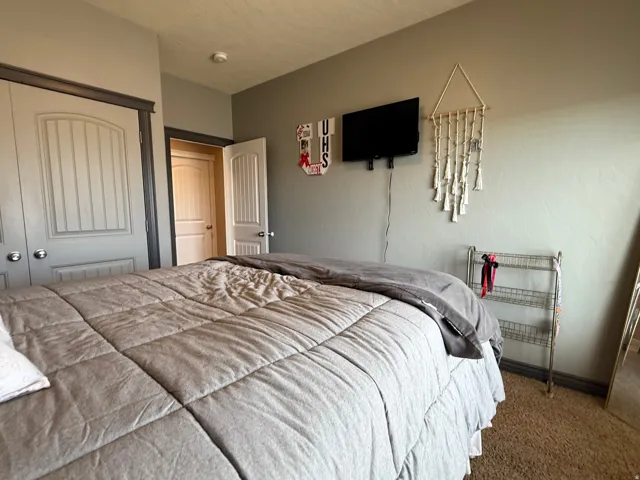 Bedroom featuring carpet and a closet