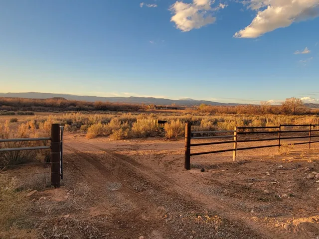 View of dirt / gravel road featuring a mountain view and a view of rural / pastoral area