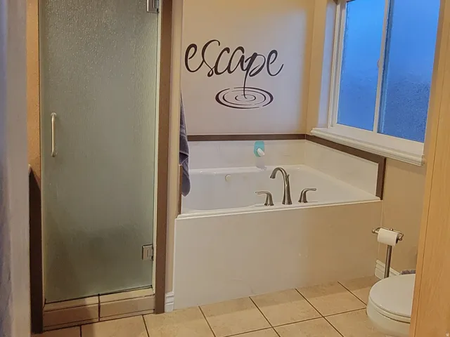 Bathroom featuring a bath, a shower stall, light tile patterned floors, and recessed lighting