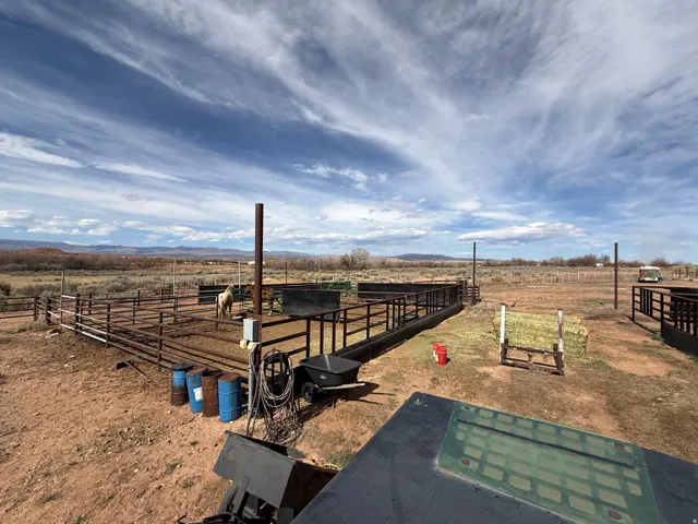 View of yard featuring a rural view, an outdoor structure, a mountain view, and an exterior structure