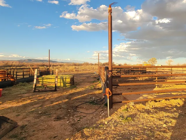 View of yard featuring a view of countryside, an outbuilding, and an exterior structure