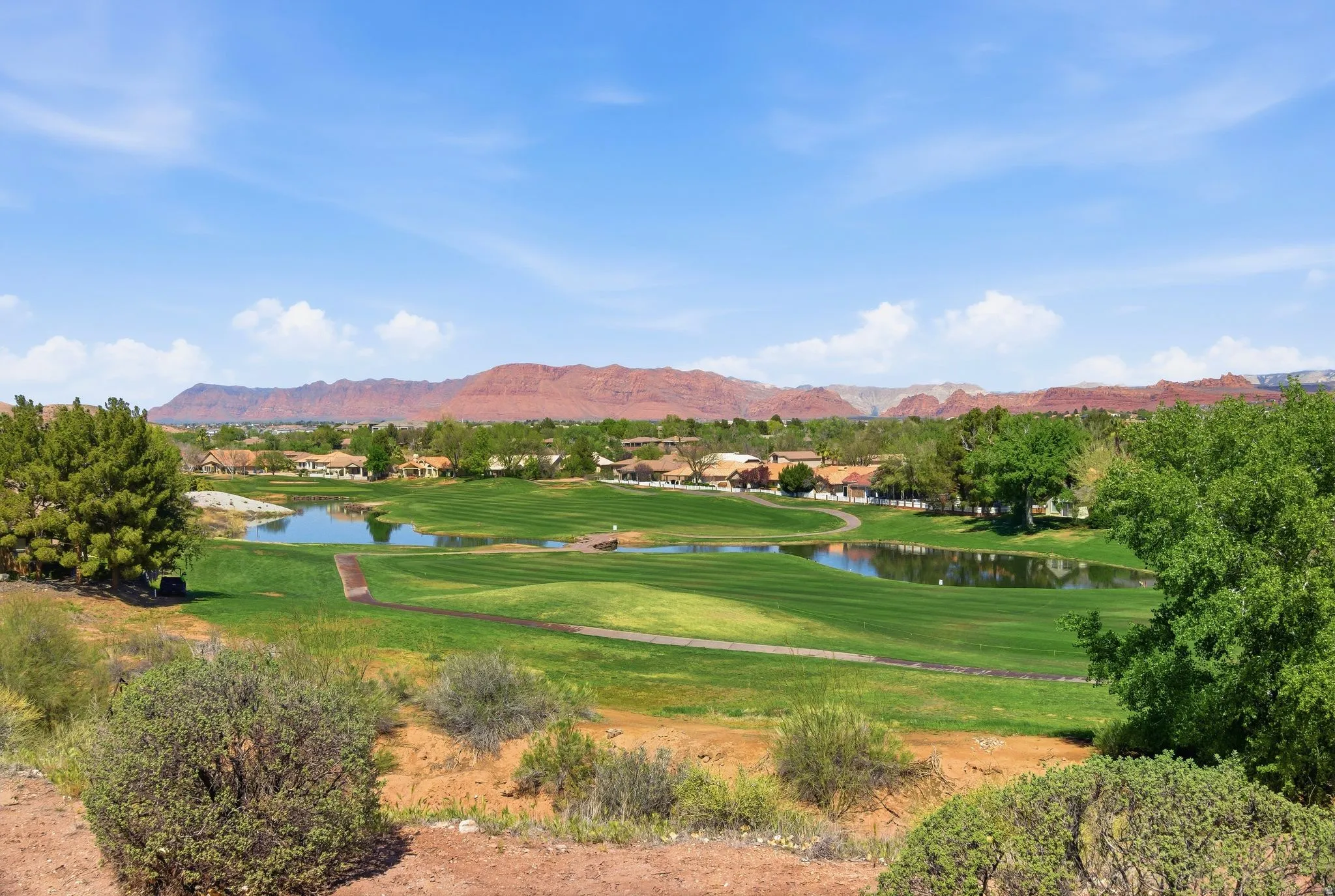 View of property's community with a water and mountain view, a residential view, and view of golf course